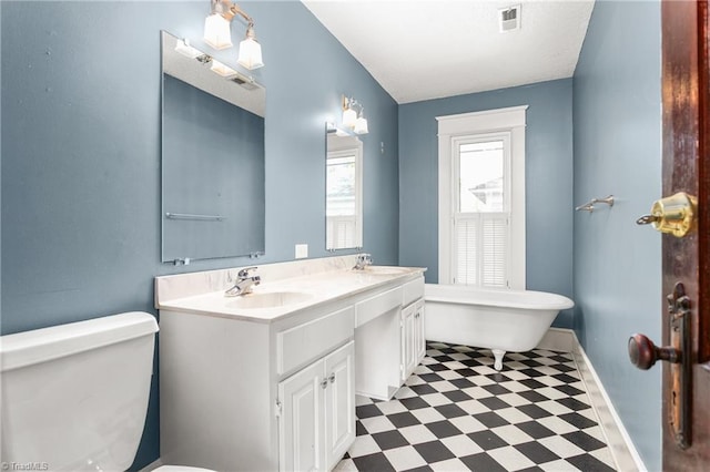 104 E Wilson St, Mebane, NC 27302 - bathroom featuring tile patterned floors, toilet, a soaking tub, and baseboards