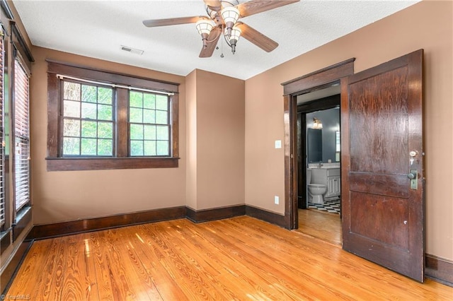 104 E Wilson St, Mebane, NC 27302 - spare room featuring baseboards, light wood finished floors, and ceiling fan