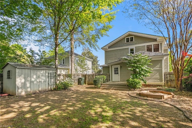 104 E Wilson St, Mebane, NC 27302 - back of property with a storage unit, a fenced backyard, and an outbuilding