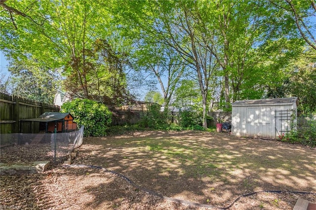 104 E Wilson St, Mebane, NC 27302 - fenced backyard featuring a storage unit and an outdoor structure