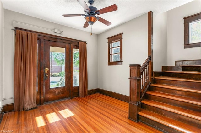 104 E Wilson St, Mebane, NC 27302 - foyer entrance featuring wood finished floors, stairs, baseboards, and a ceiling fan