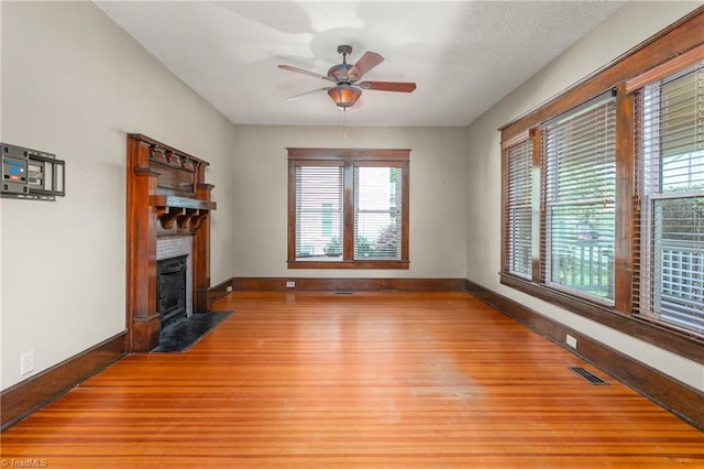 104 E Wilson St, Mebane, NC 27302 - unfurnished living room featuring baseboards, light wood-style flooring, healthy amount of natural light, and ceiling fan