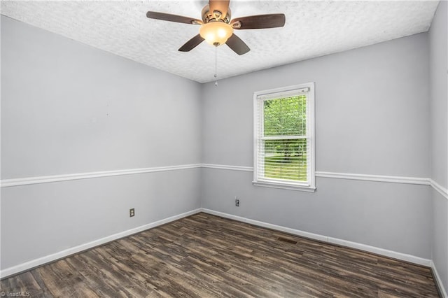 spare room with a ceiling fan, a textured ceiling, baseboards, and wood finished floors