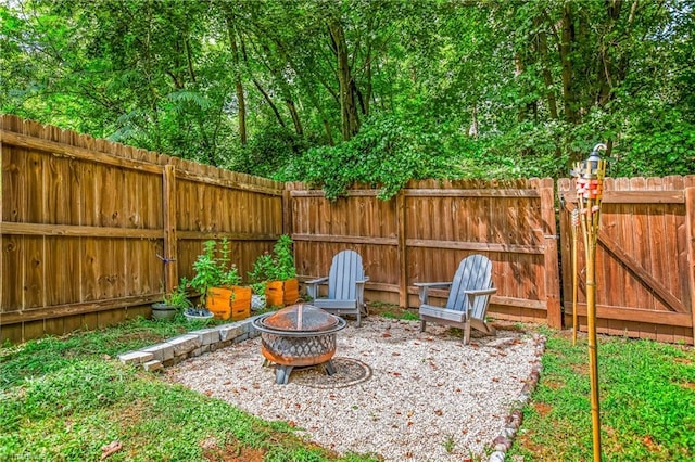 view of patio featuring an outdoor fire pit and fence