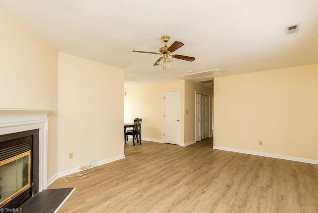 unfurnished living room with ceiling fan and light hardwood / wood-style floors