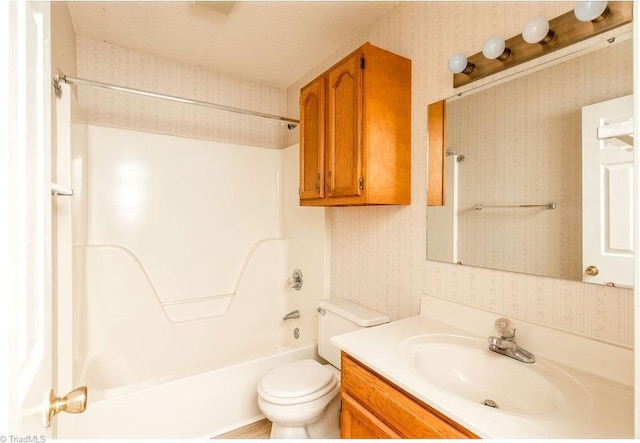 full bathroom featuring vanity,  shower combination, and toilet