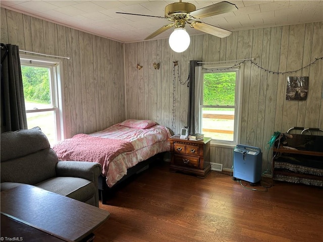 813 Blevins Store Rd, Mount Airy, NC 27030 - bedroom with wooden walls, wood finished floors, and a ceiling fan