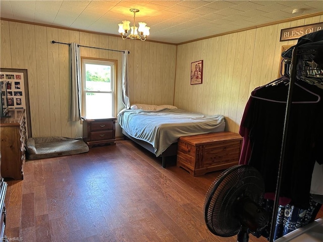 813 Blevins Store Rd, Mount Airy, NC 27030 - bedroom featuring a chandelier, ornamental molding, wood finished floors, and wooden walls