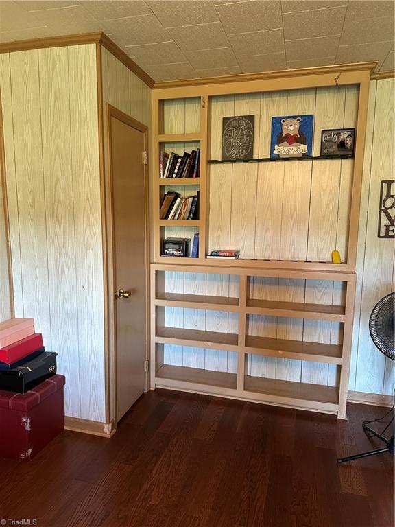 813 Blevins Store Rd, Mount Airy, NC 27030 - detailed view of built in features, wood walls, baseboards, wood finished floors, and crown molding