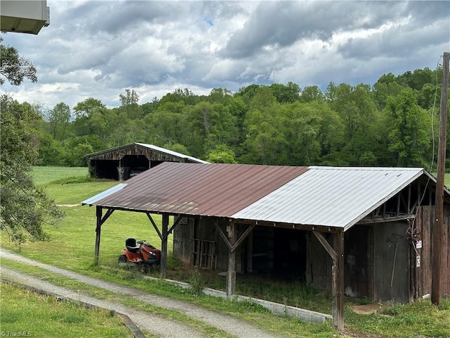 813 Blevins Store Rd, Mount Airy, NC 27030 - view of home's community featuring a wooded view, an outbuilding, a yard, a carport, and an outdoor structure
