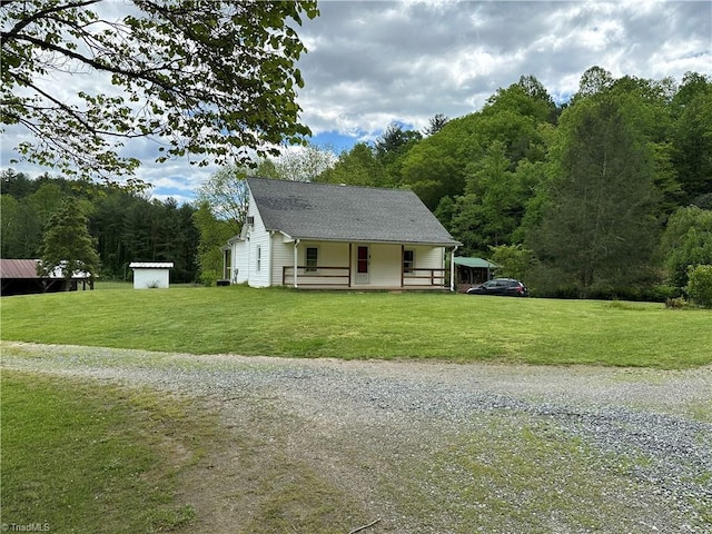 813 Blevins Store Rd, Mount Airy, NC 27030 - view of front of home with covered porch, a front yard, driveway, and a view of trees