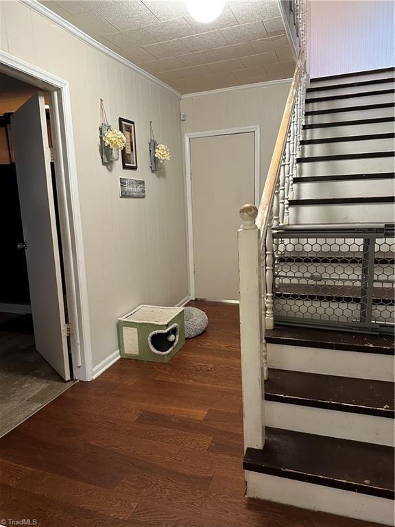 813 Blevins Store Rd, Mount Airy, NC 27030 - staircase with crown molding, wood finished floors, and baseboards