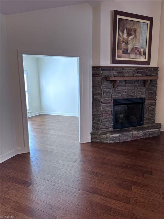 unfurnished living room with wood-type flooring and a fireplace