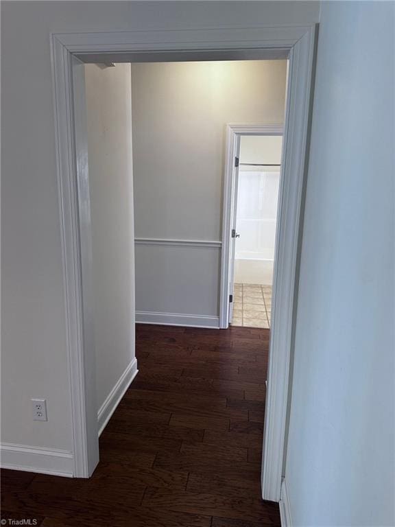 corridor with dark wood-type flooring