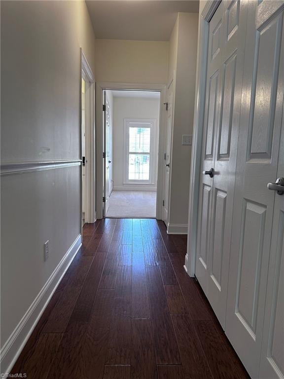 corridor with dark hardwood / wood-style floors