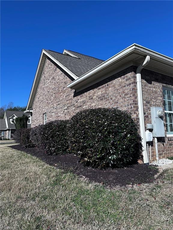 view of side of home featuring a lawn