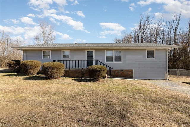 back of house with a wooden deck and a lawn