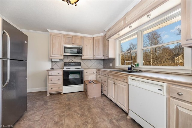 753 Wolf Island Rd, Reidsville, NC 27320 - kitchen with light brown cabinetry, sink, tasteful backsplash, crown molding, and stainless steel appliances
