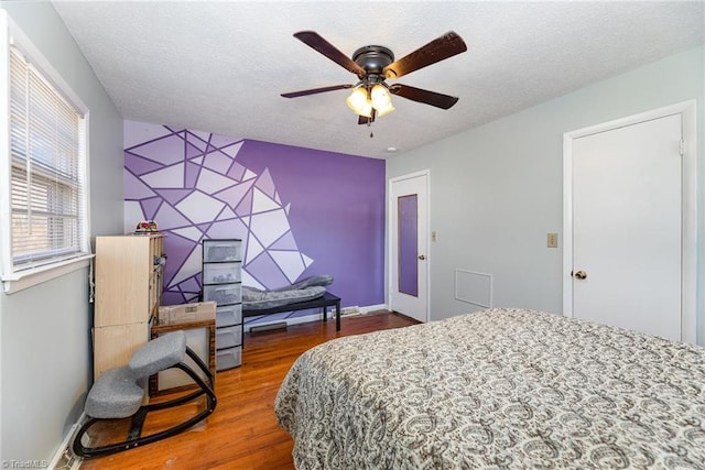 753 Wolf Island Rd, Reidsville, NC 27320 - bedroom featuring ceiling fan, dark wood-type flooring, and a textured ceiling