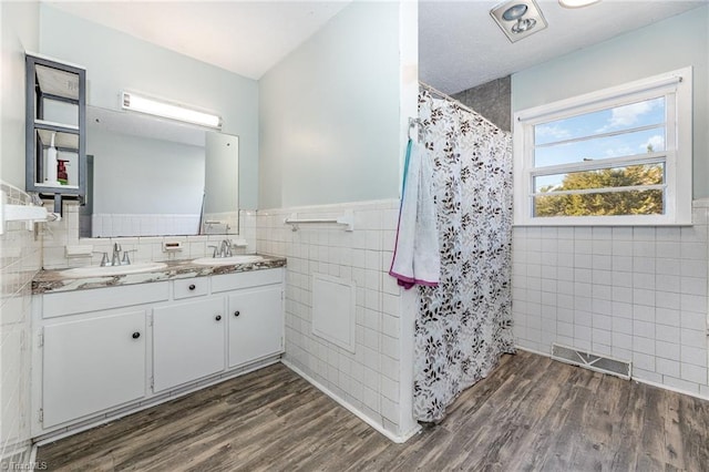 753 Wolf Island Rd, Reidsville, NC 27320 - bathroom featuring hardwood / wood-style flooring, vanity, tile walls, and curtained shower