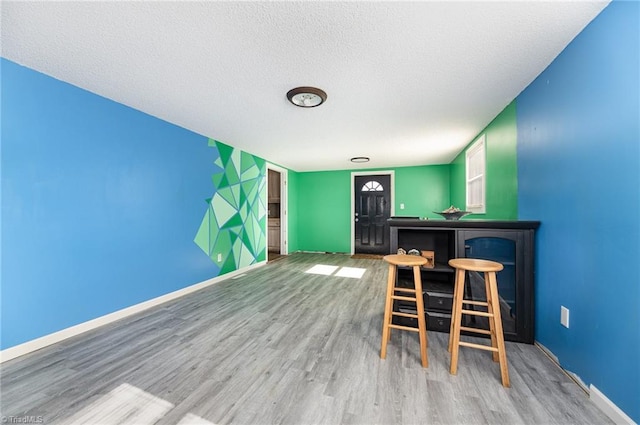 753 Wolf Island Rd, Reidsville, NC 27320 - interior space with hardwood / wood-style flooring, a textured ceiling, and indoor bar