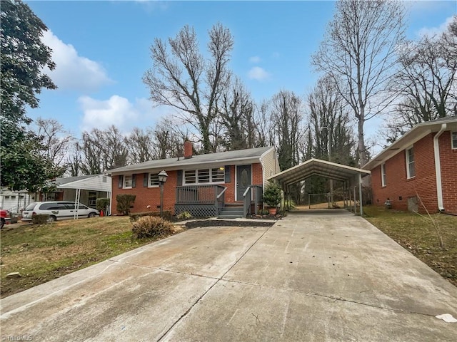 view of front facade with a front yard and a carport