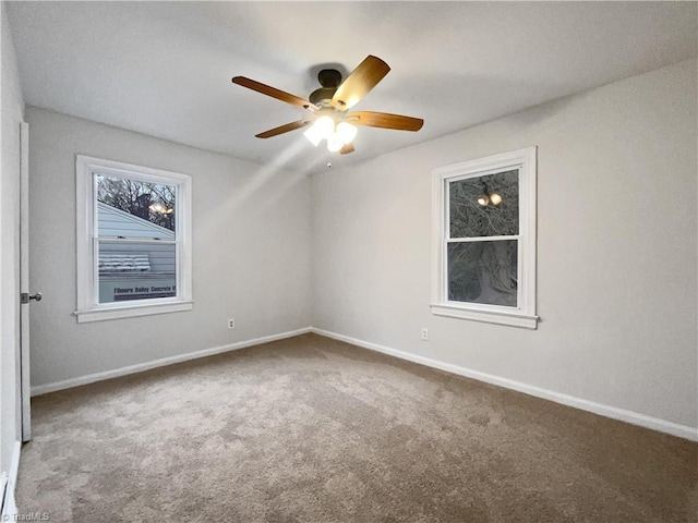 carpeted spare room with ceiling fan