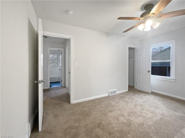 unfurnished bedroom featuring ceiling fan and light carpet