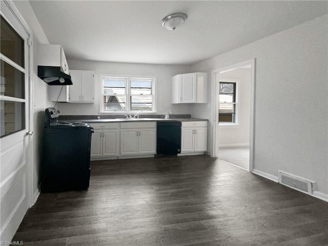 kitchen with black appliances, dark hardwood / wood-style flooring, white cabinets, and sink