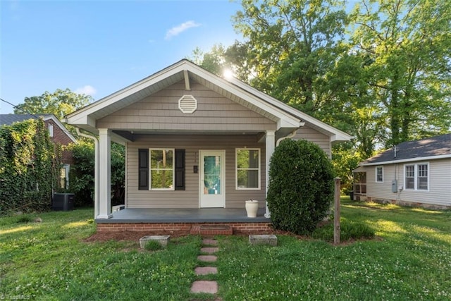 712 Englewood St, Greensboro, NC 27403 - view of front of home featuring a porch, a front yard, and central AC unit