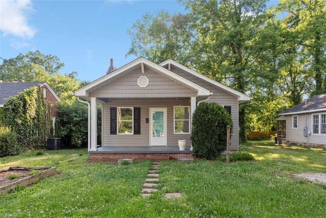 712 Englewood St, Greensboro, NC 27403 - bungalow with covered porch, a front lawn, and central AC unit