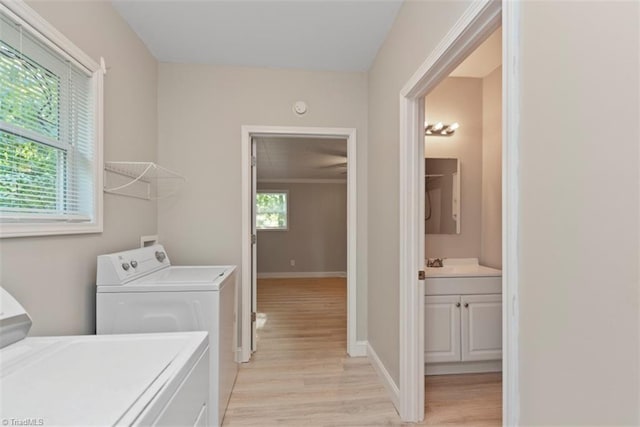 712 Englewood St, Greensboro, NC 27403 - laundry room featuring separate washer and dryer, light wood-type flooring, and baseboards
