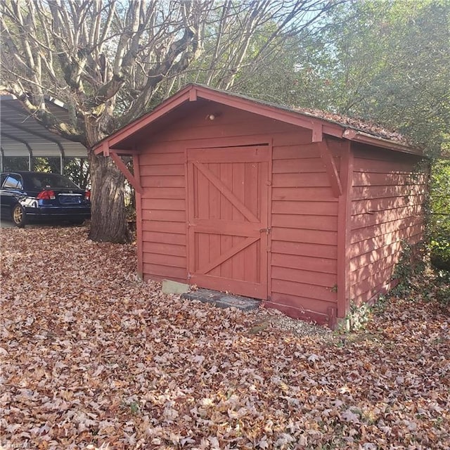 view of outbuilding with a carport