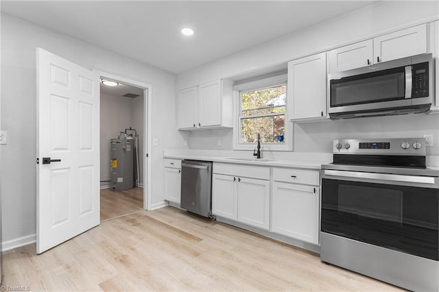 kitchen featuring white cabinetry, sink, and appliances with stainless steel finishes