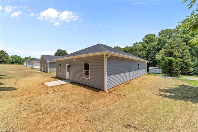 3145 Chapel St, Walkertown, NC 27051 - view of home's exterior with a yard and a shingled roof