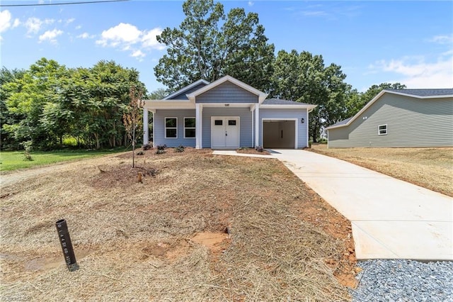 3145 Chapel St, Walkertown, NC 27051 - view of front of house with concrete driveway, a garage, and a porch