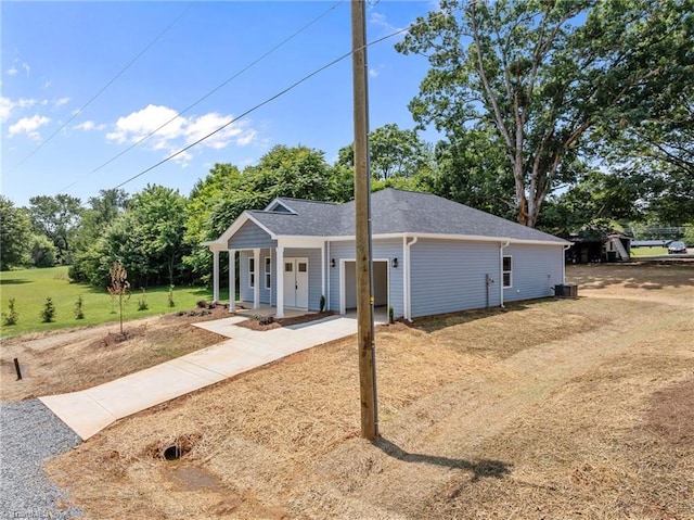 3145 Chapel St, Walkertown, NC 27051 - ranch-style house with concrete driveway, a porch, view of scattered trees, and a shingled roof
