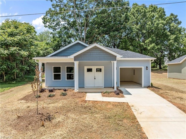 3145 Chapel St, Walkertown, NC 27051 - view of front of property featuring a garage, driveway, and a porch