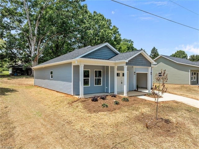 3145 Chapel St, Walkertown, NC 27051 - view of front facade featuring a garage, driveway, and covered porch