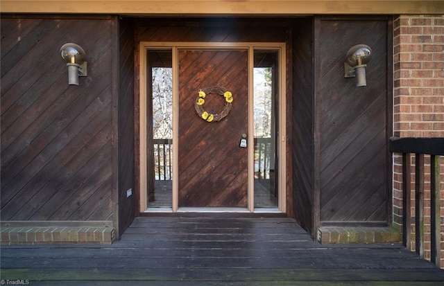 view of exterior entry featuring brick siding