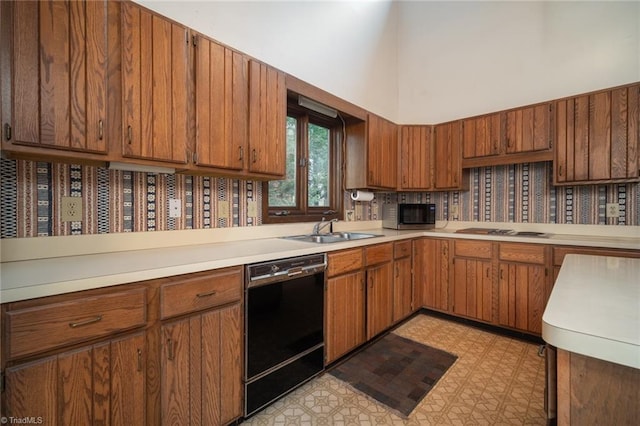 kitchen featuring black dishwasher, stainless steel microwave, light countertops, light floors, and a sink