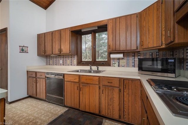 kitchen with dishwasher, stainless steel microwave, brown cabinets, light countertops, and a sink