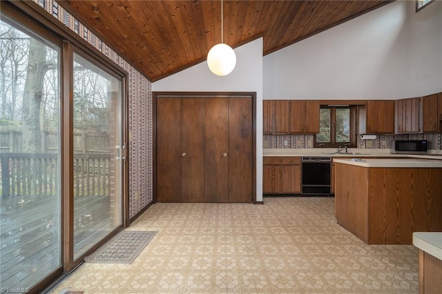 kitchen with black dishwasher, brown cabinetry, wood ceiling, decorative light fixtures, and light countertops