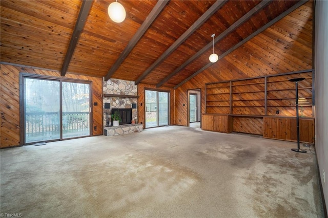 unfurnished living room featuring wooden ceiling, a healthy amount of sunlight, wood walls, and beamed ceiling