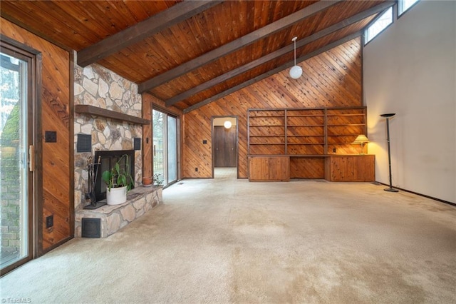 unfurnished living room with high vaulted ceiling, wooden walls, carpet floors, wood ceiling, and beam ceiling