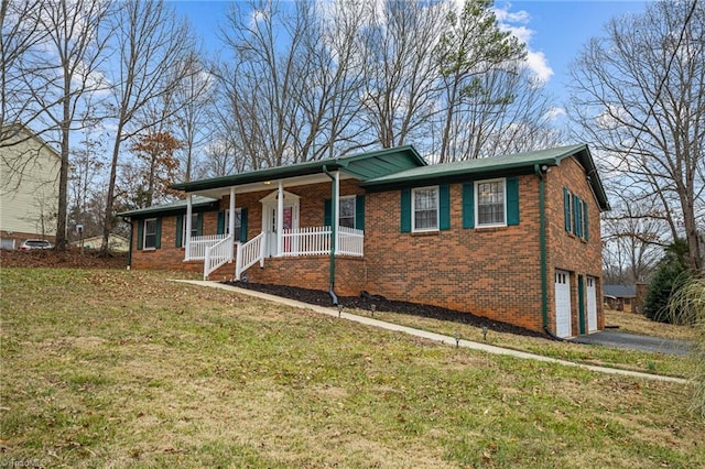 view of front of property with a garage, a porch, and a front yard