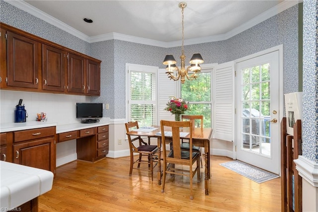 6516 Dornoch Dr, Greensboro, NC 27410 - dining space with wallpapered walls, ornamental molding, light wood-type flooring, plenty of natural light, and a chandelier