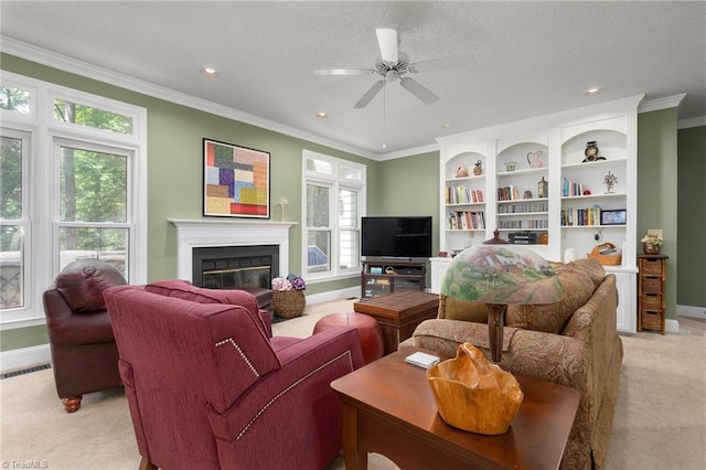 6516 Dornoch Dr, Greensboro, NC 27410 - living area with light carpet, baseboards, crown molding, ceiling fan, and a glass covered fireplace