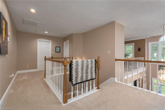 6516 Dornoch Dr, Greensboro, NC 27410 - corridor featuring an upstairs landing, carpet flooring, a textured ceiling, baseboards, and recessed lighting