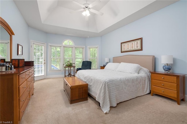 6516 Dornoch Dr, Greensboro, NC 27410 - bedroom with light colored carpet, access to outside, a tray ceiling, and a ceiling fan